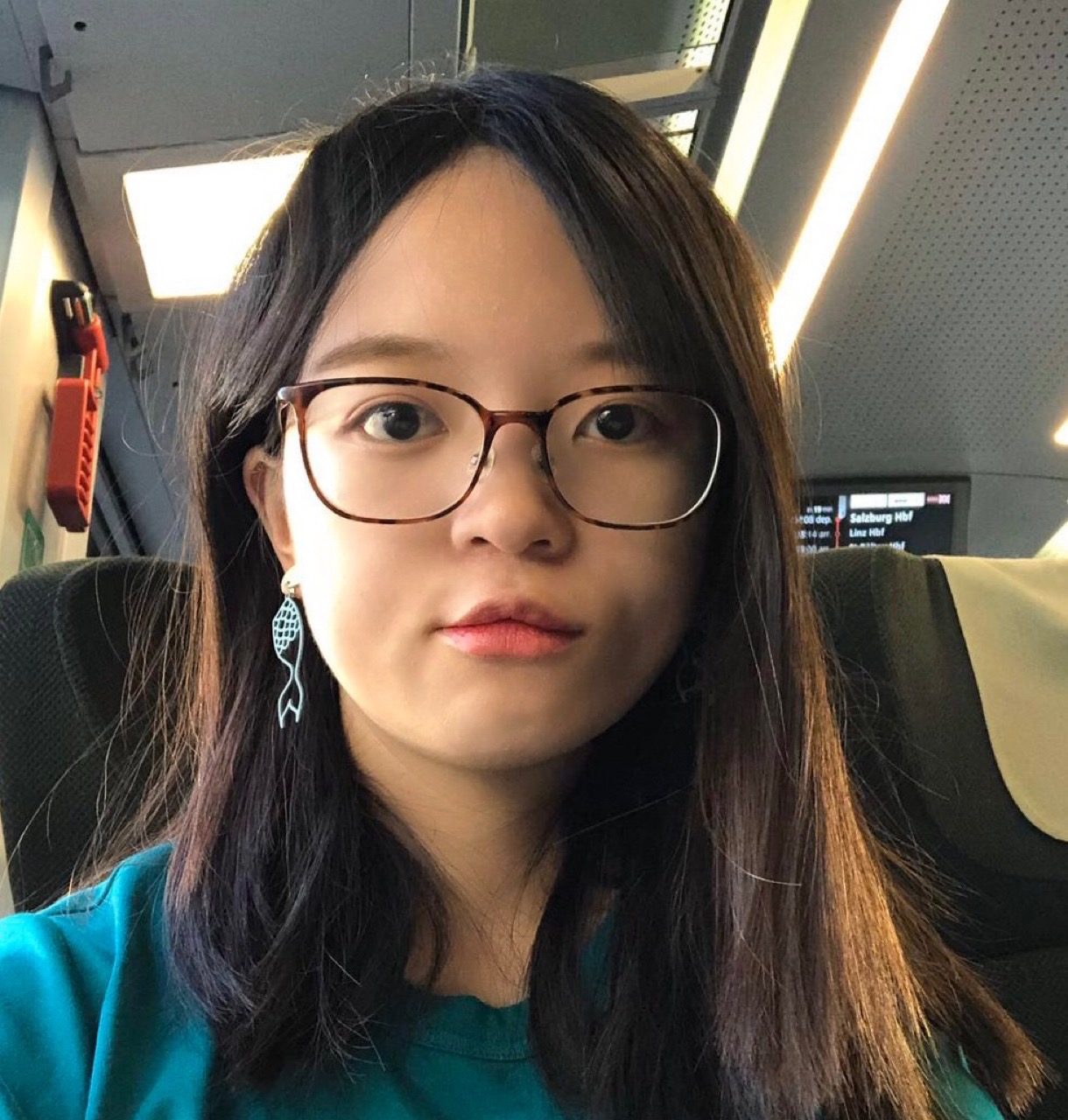 a Chinese female with glasses, long hair, and a green T-shirt